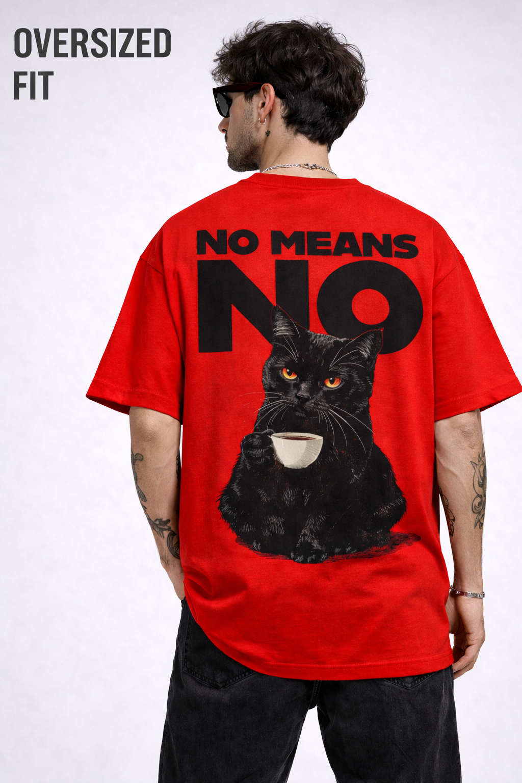 Person wearing a red t-shirt with a black cat graphic and text on the back, on a white background.