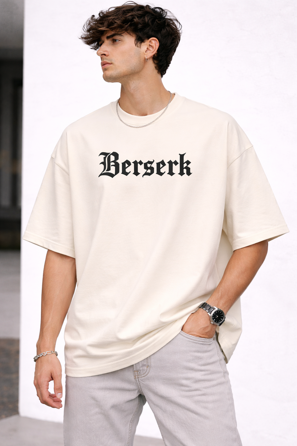 Man wearing a white t-shirt with 'Berserk' text on a plain background
