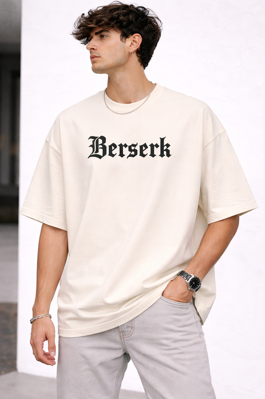 Man wearing a white t-shirt with 'Berserk' text on a plain background