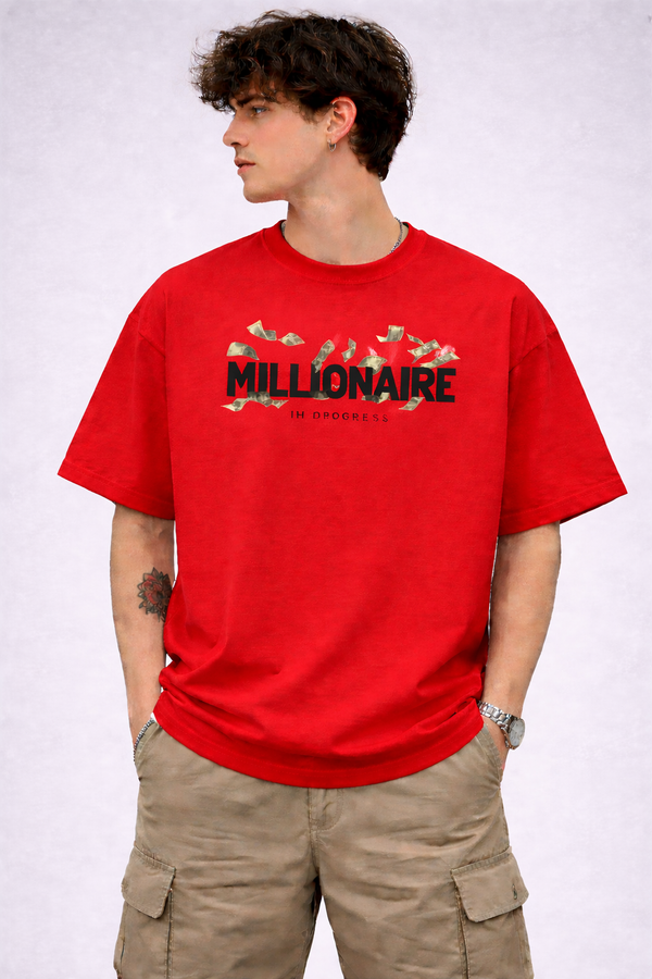 Person wearing a red t-shirt with 'Millionaire' text on a plain background