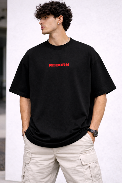 Man wearing a black t-shirt with 'REBORN' in red text on a white background