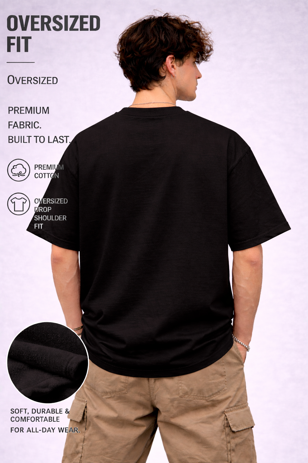 Person wearing an oversized black t-shirt with text detailing features on a white background
