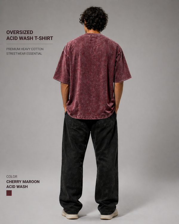 Person wearing an oversized acid wash t-shirt with text describing the product on a gray background