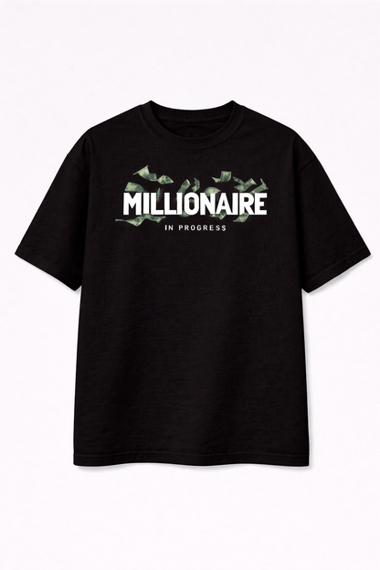Black t-shirt with 'Millionaire in Progress' text and dollar sign graphics on a white background