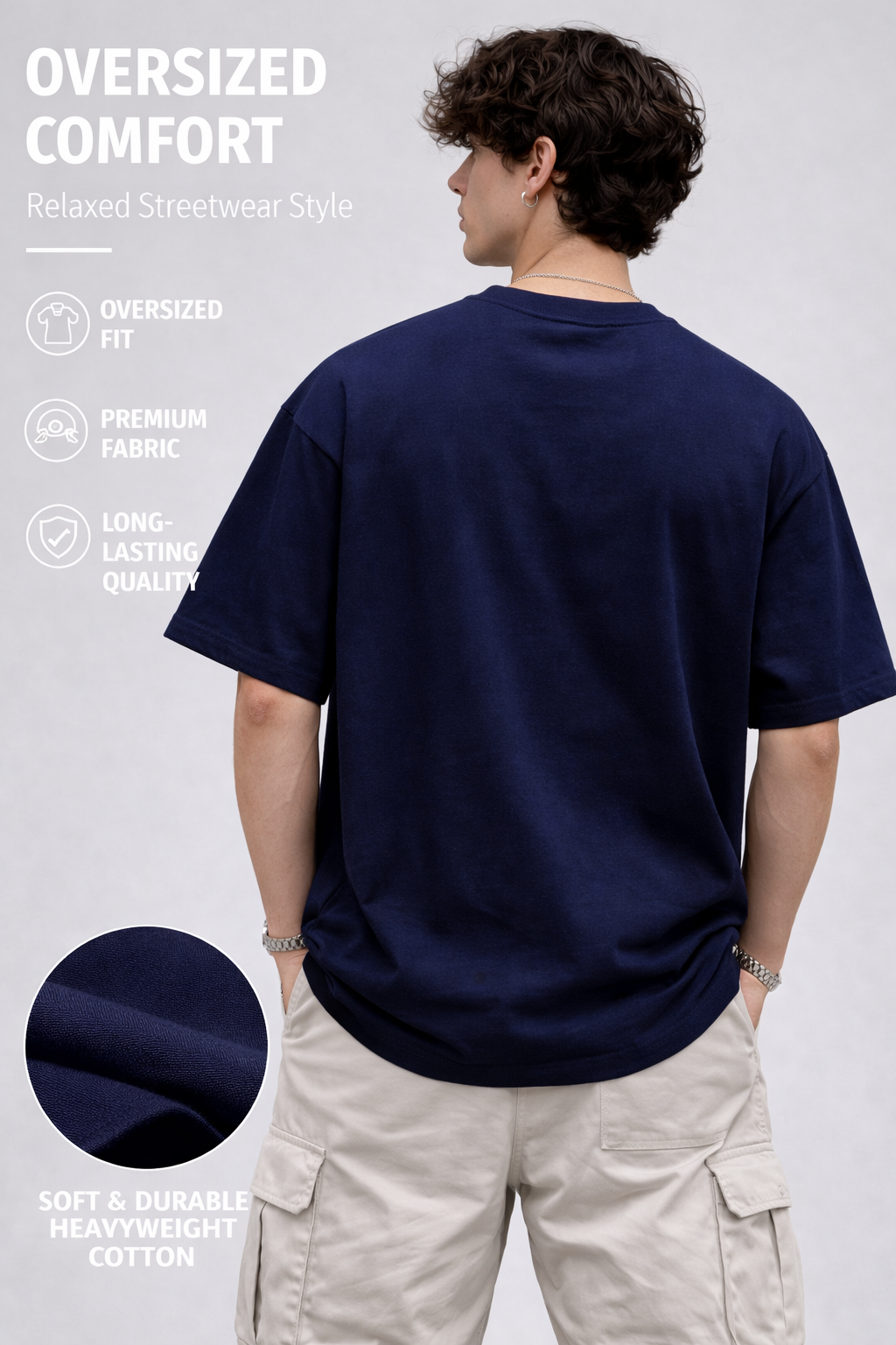 Person wearing a navy blue oversized t-shirt with text and icons about comfort and fabric quality on a white background.
